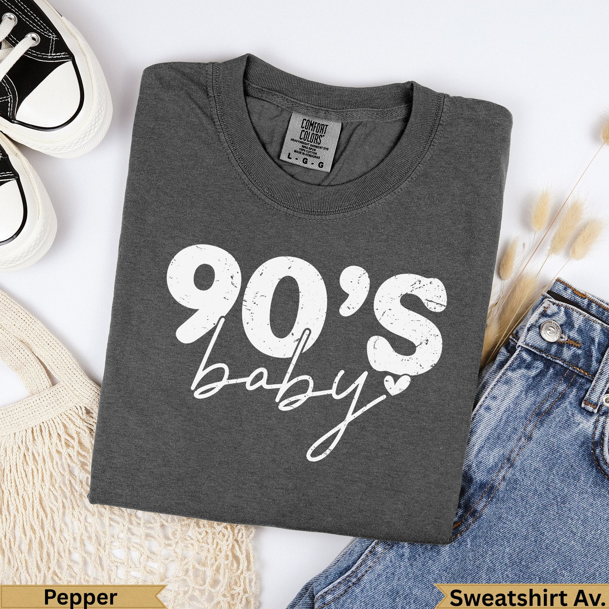 Dark gray t-shirt with "90's baby" text, paired with jeans.