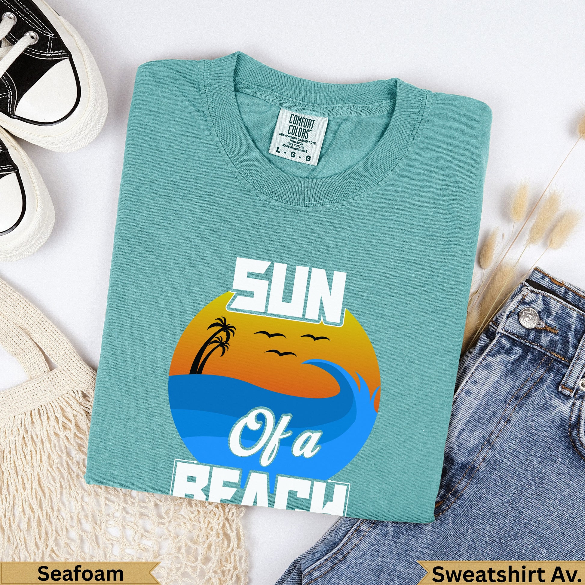 Teal t-shirt with "SUN Of a BEACH" text and a sunset graphic.