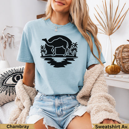 Light blue t-shirt with a black camel silhouette and palm trees graphic.
