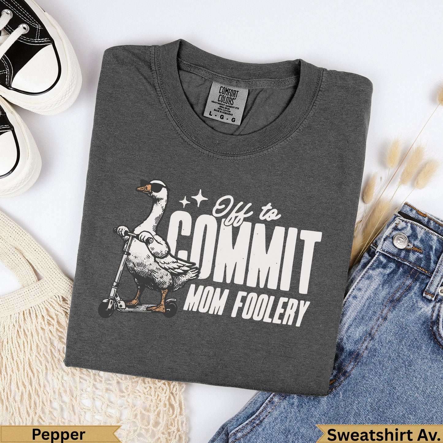 Dark grey t-shirt with goose on scooter graphic and "Off to Commit Mom Foolery" text.