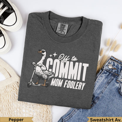 Dark grey t-shirt with goose on scooter graphic and "Off to Commit Mom Foolery" text.