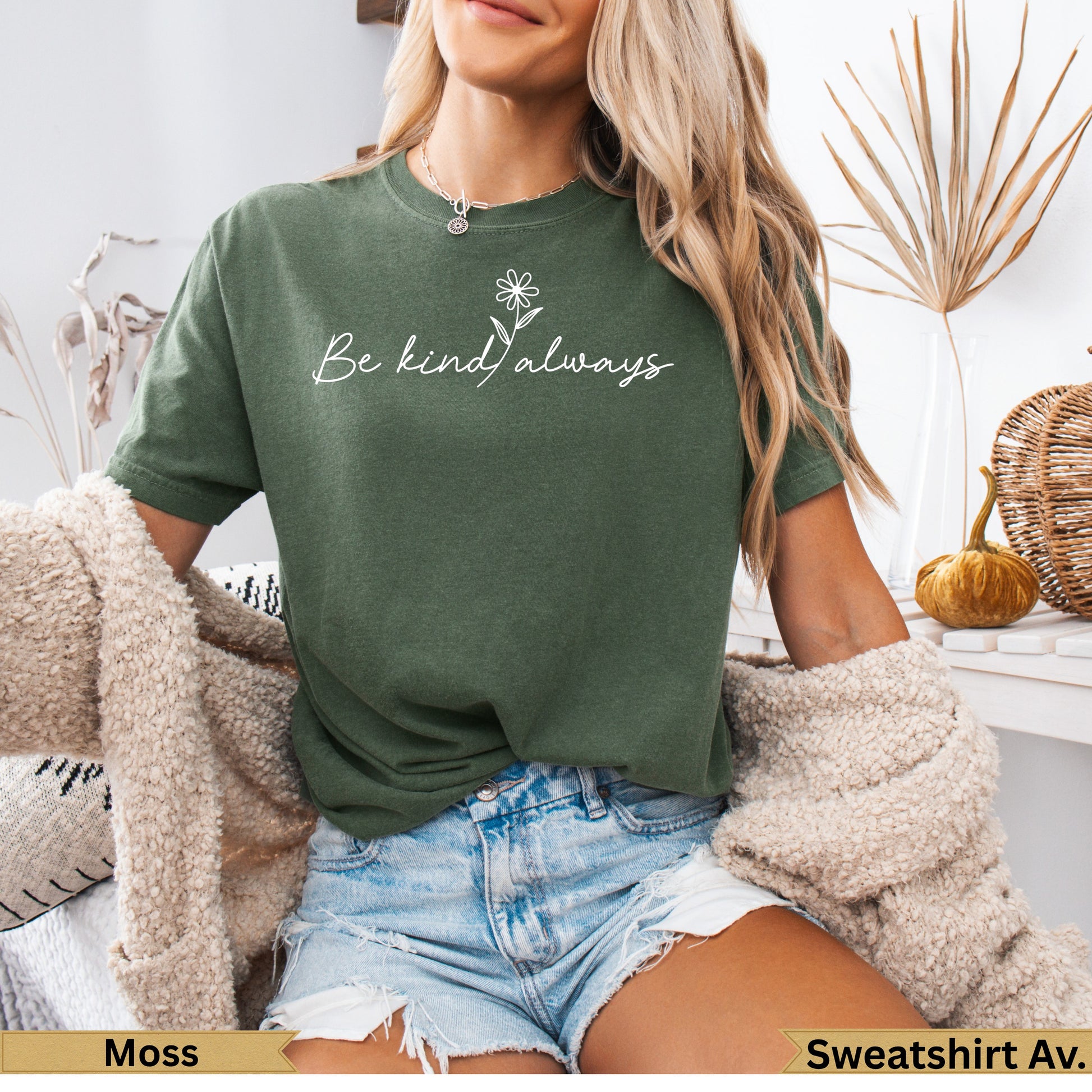 Green t-shirt with "Be Kind Always" floral text, worn by a woman.