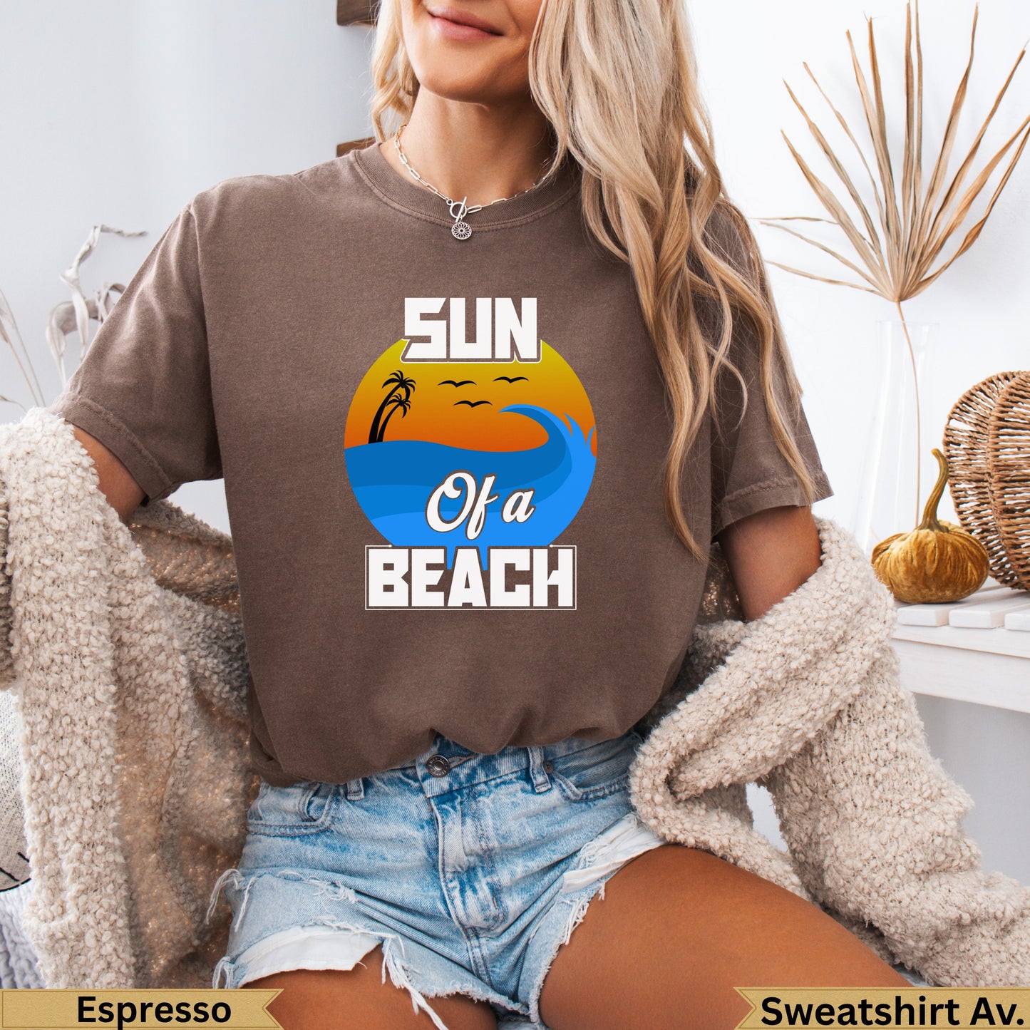 Brown t-shirt with "Sun Of A Beach" text, ocean waves, and palm trees design.