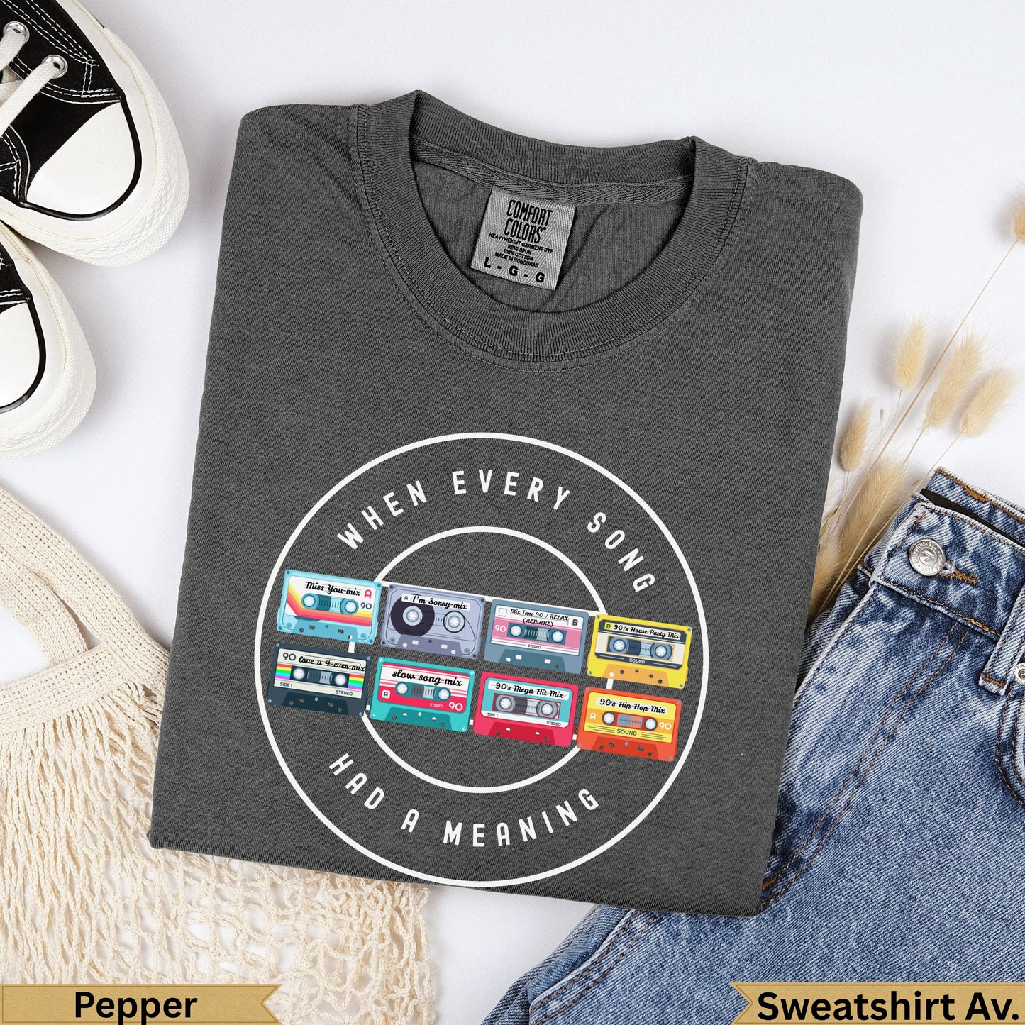 Dark gray sweatshirt with "When Every Song Had a Meaning" and colorful cassette tape graphic.