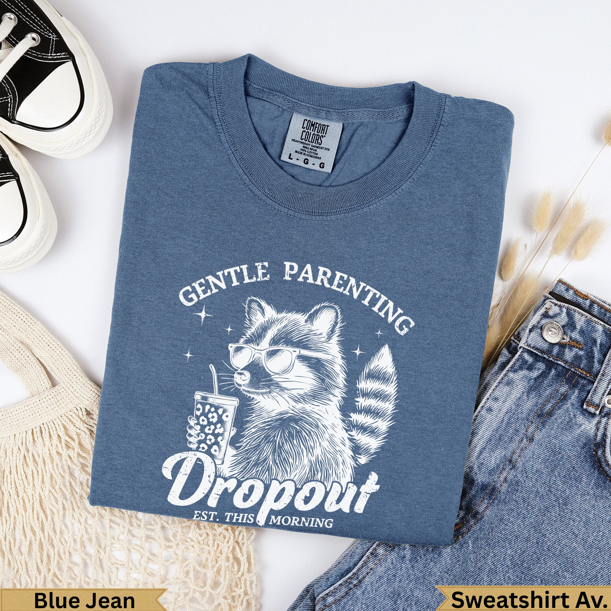 Blue Jean Comfort Colors heavyweight garment dye sweatshirt featuring a raccoon with sunglasses.