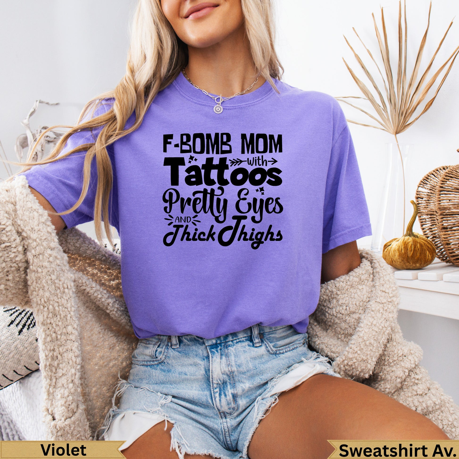 Purple t-shirt with "F-bomb mom with pretty eyes and thick thighs" text.