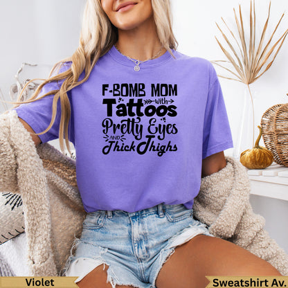 Purple t-shirt with "F-bomb mom with pretty eyes and thick thighs" text.