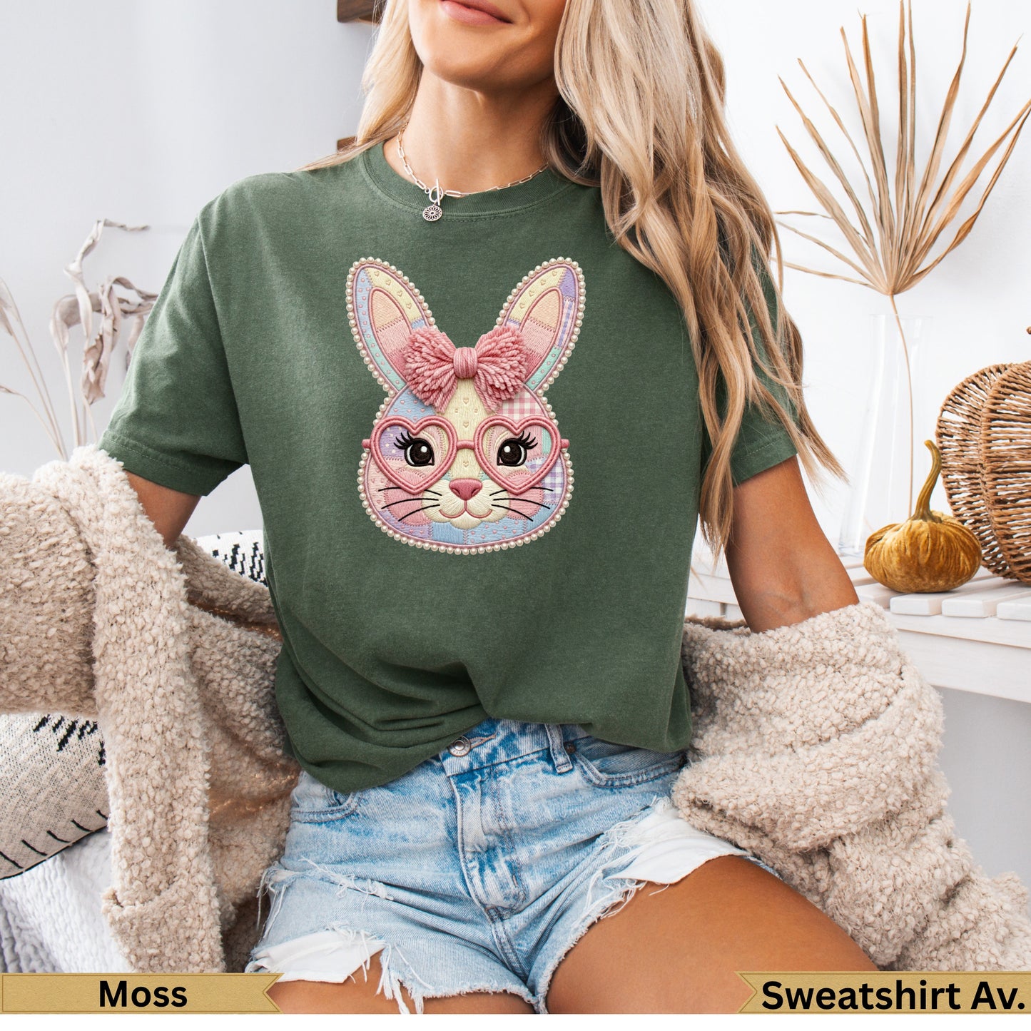 Green t-shirt with pastel bunny graphic wearing heart-shaped glasses and pink bow.