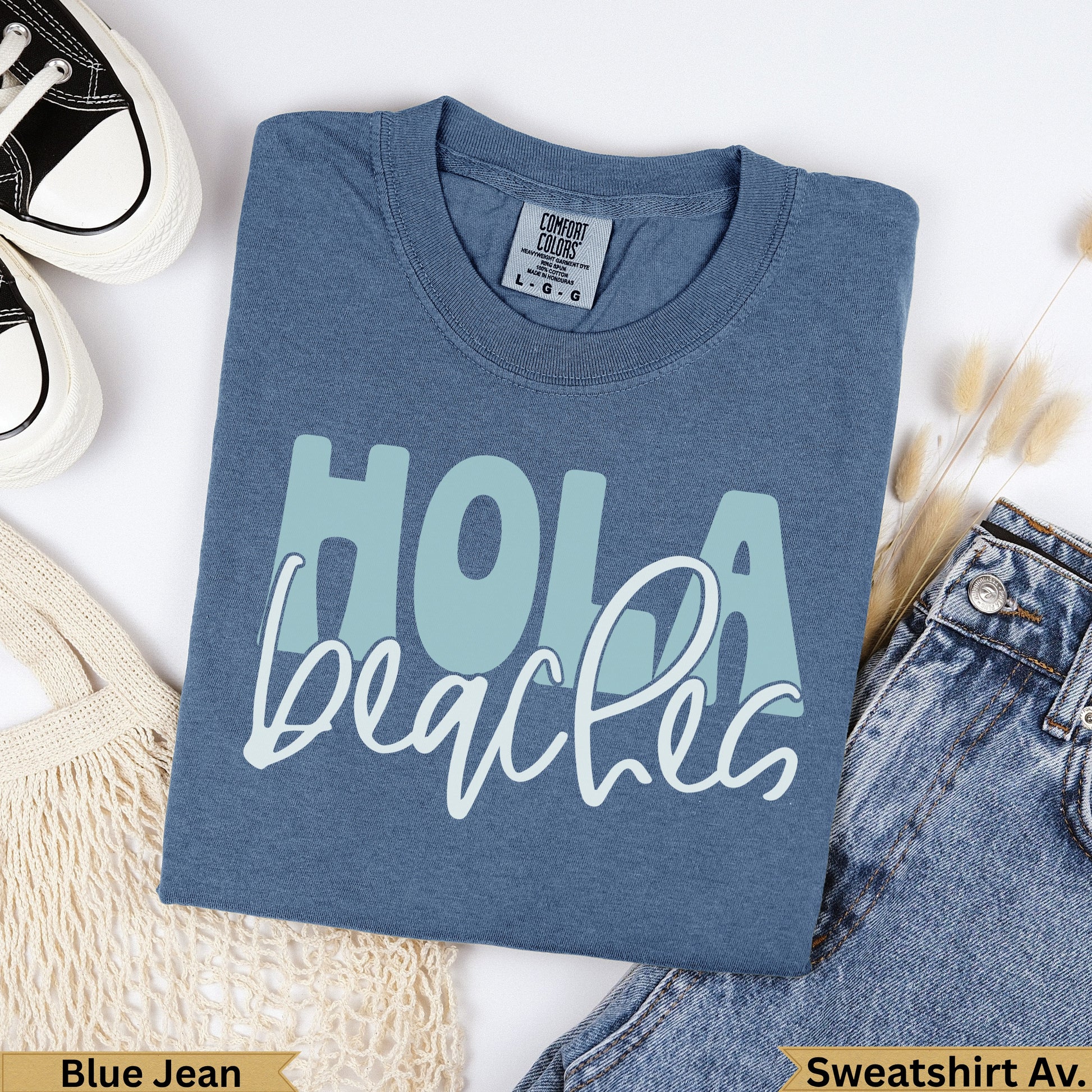 Blue jean Comfort Colors sweatshirt with "Hola Beaches" text.