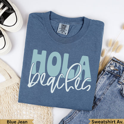 Blue jean Comfort Colors sweatshirt with "Hola Beaches" text.
