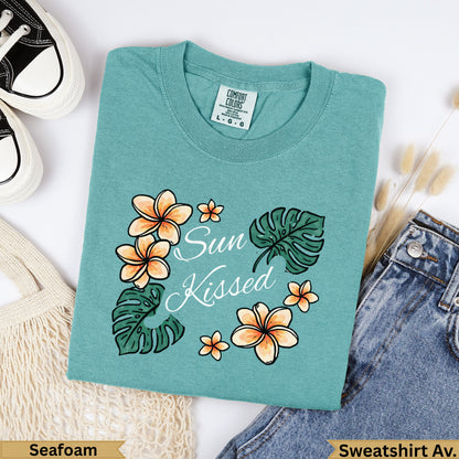 Teal sweatshirt with "Sun Kissed" text and floral design.