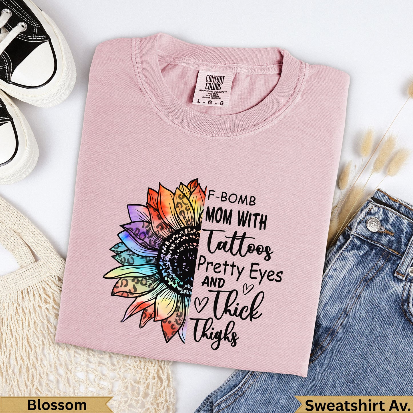 Pink graphic t-shirt with "F-Bomb Mom" text and a colorful sunflower design.