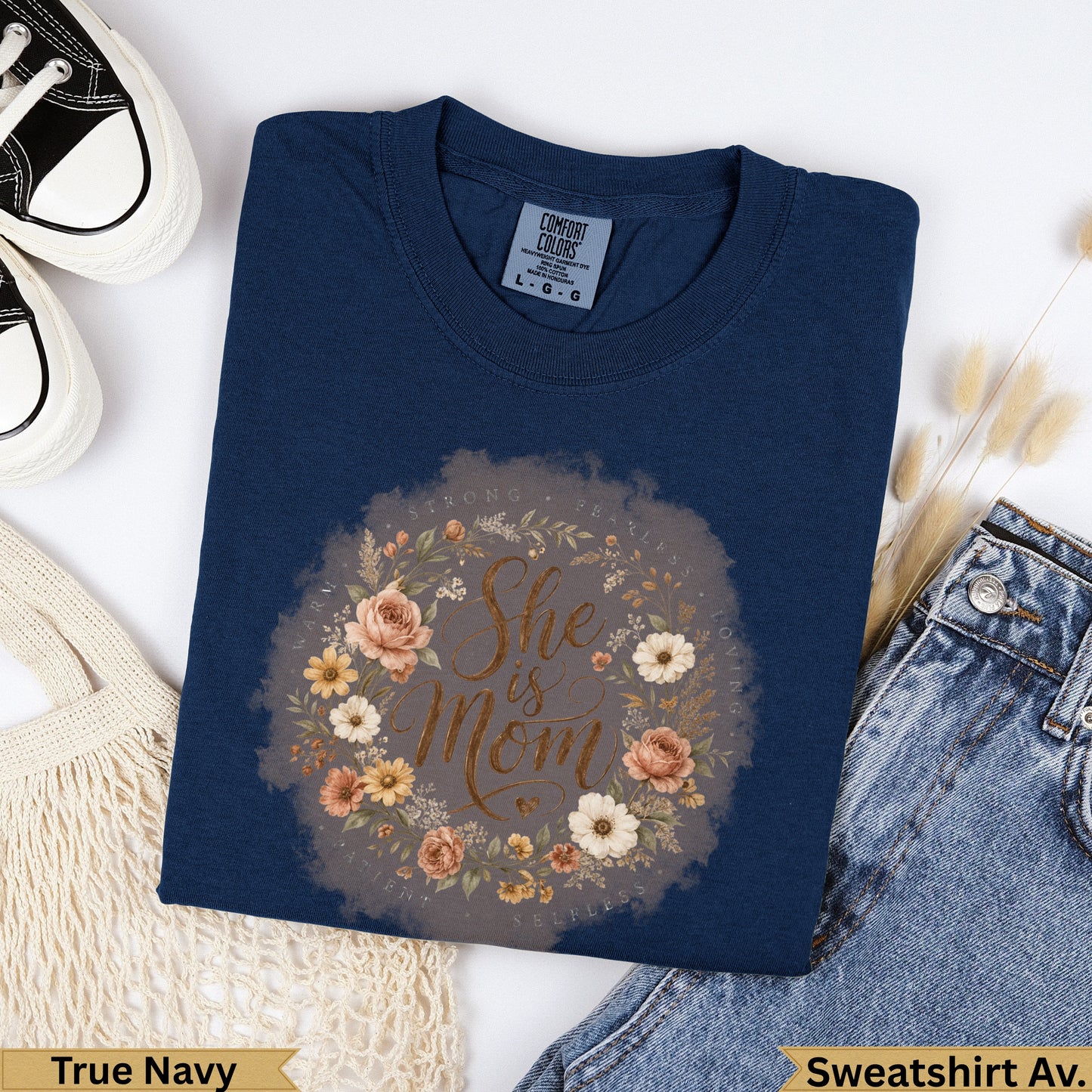 Navy blue sweatshirt with floral "She is Mom" design and size tag.