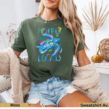 Green t-shirt with a colorful sea turtle and "RESPECT THE LOCALS" text.