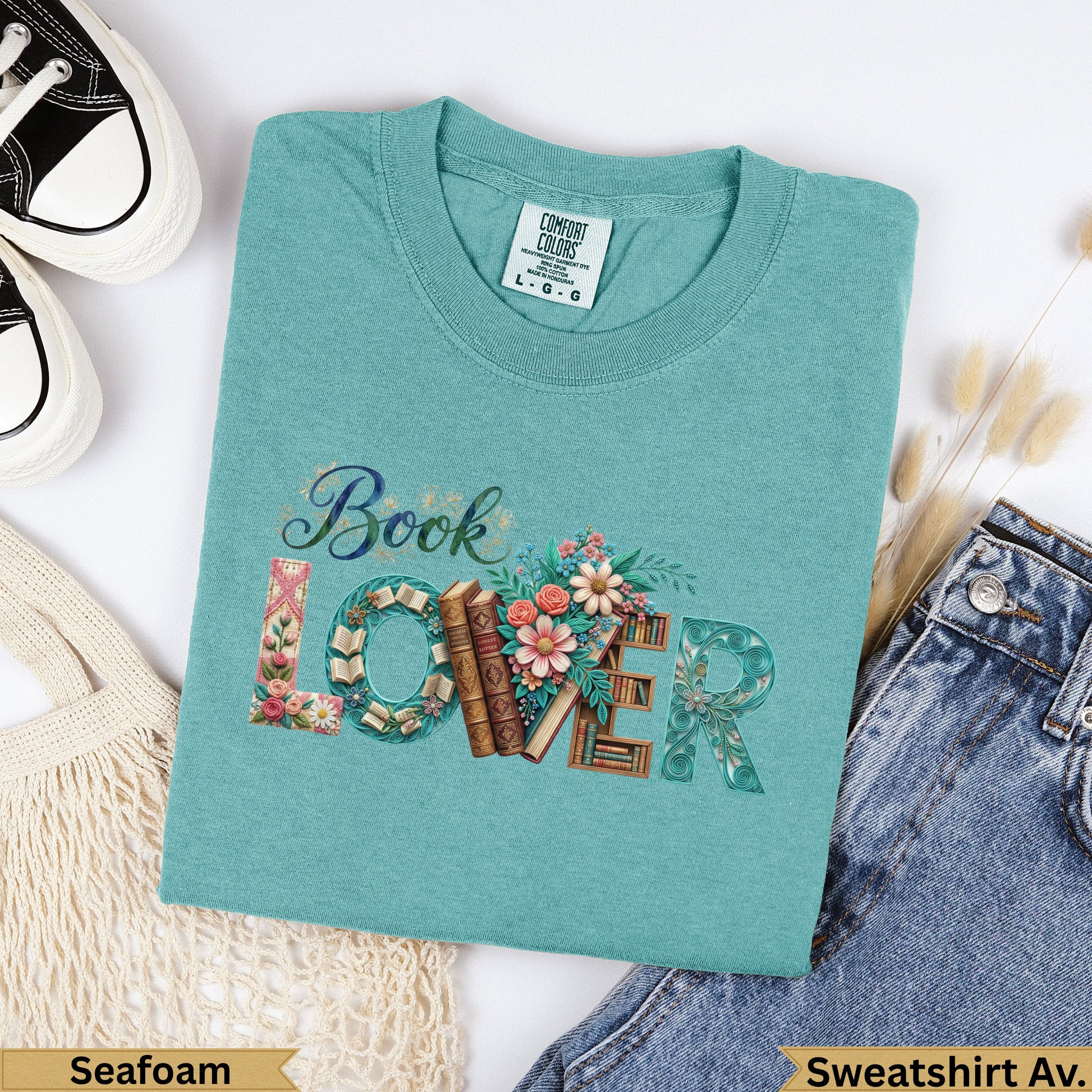 Seafoam green Comfort Colors sweatshirt with "Book Lover" text and floral design.