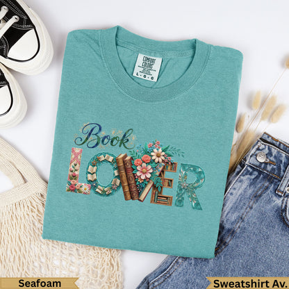 Seafoam green Comfort Colors sweatshirt with "Book Lover" text and floral design.