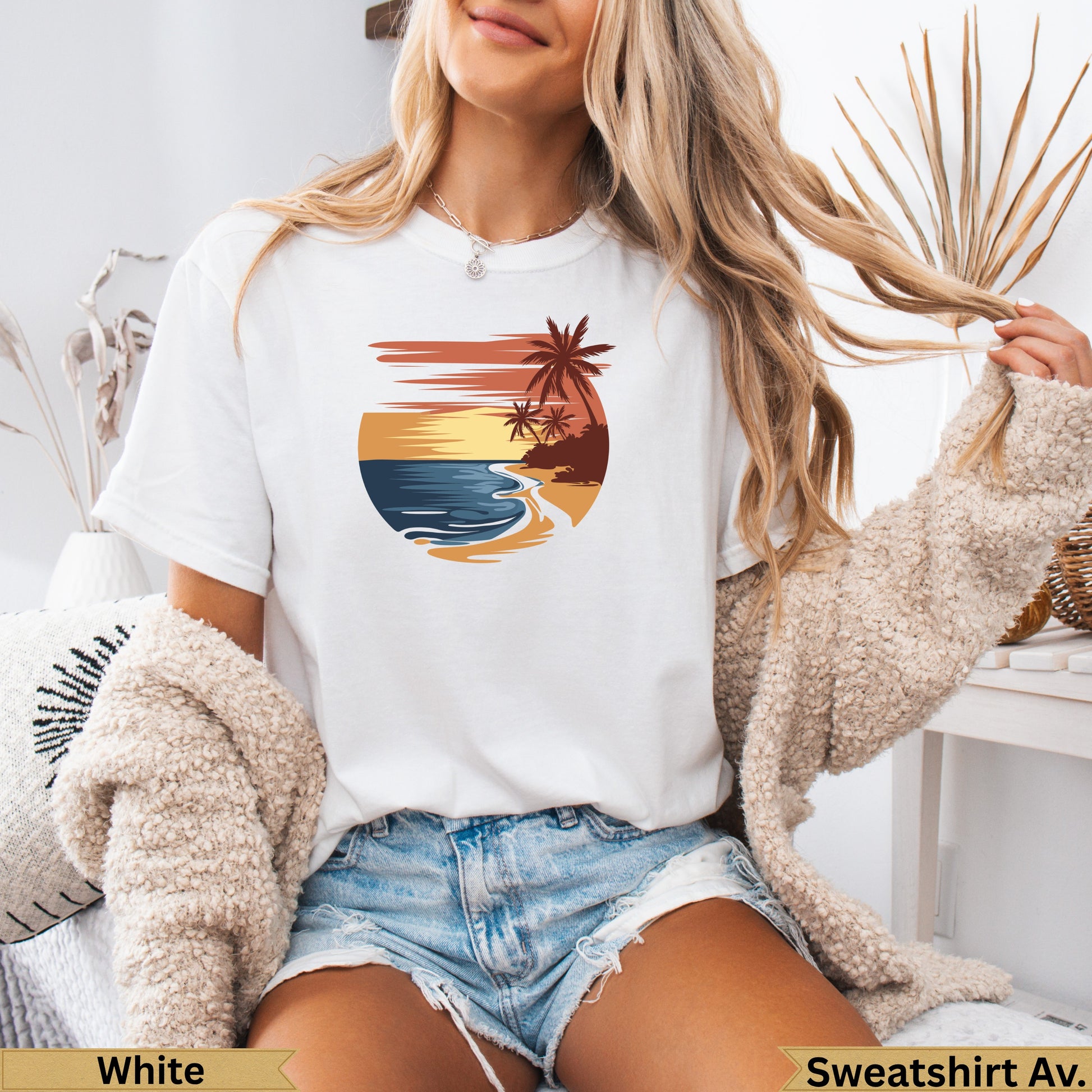 White t-shirt with a sunset beach graphic featuring palm trees and waves.