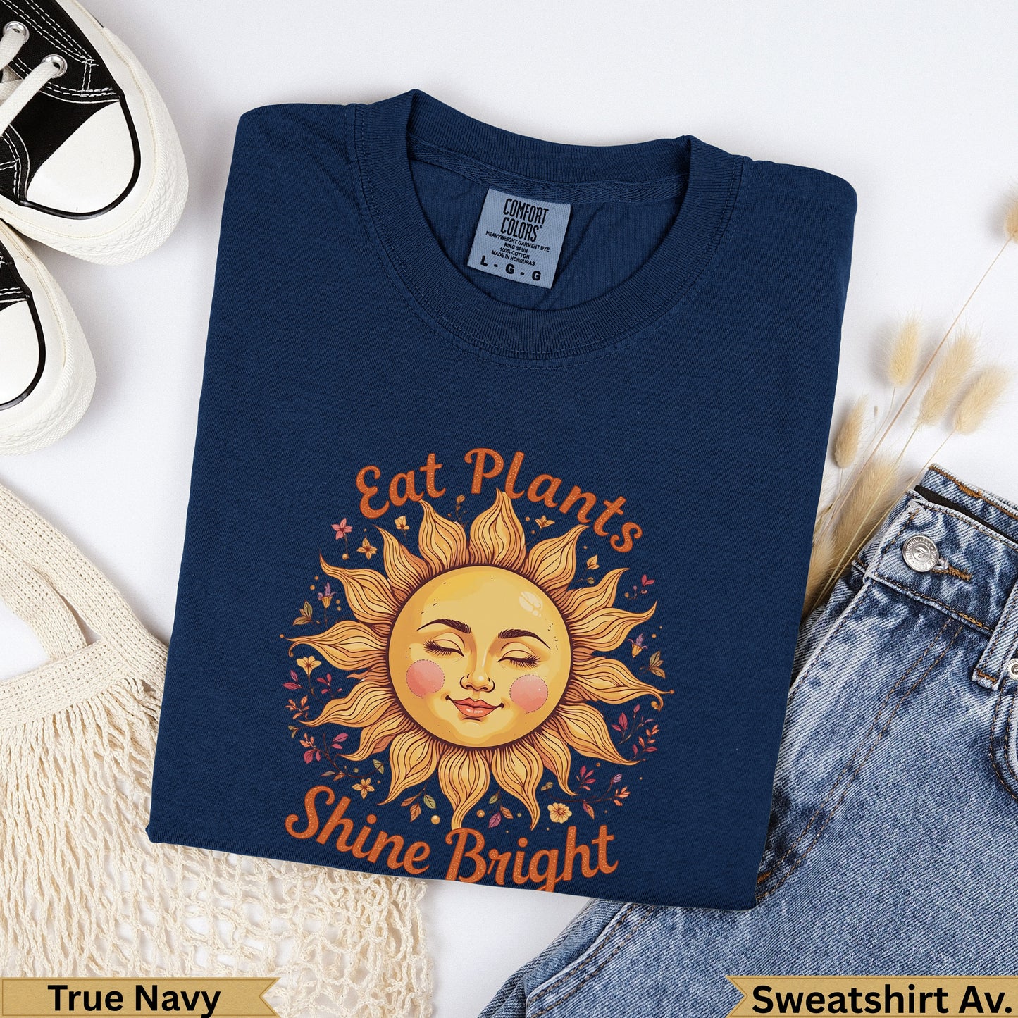 Navy crewneck sweatshirt with "Eat Plants Shine Bright" sun graphic.