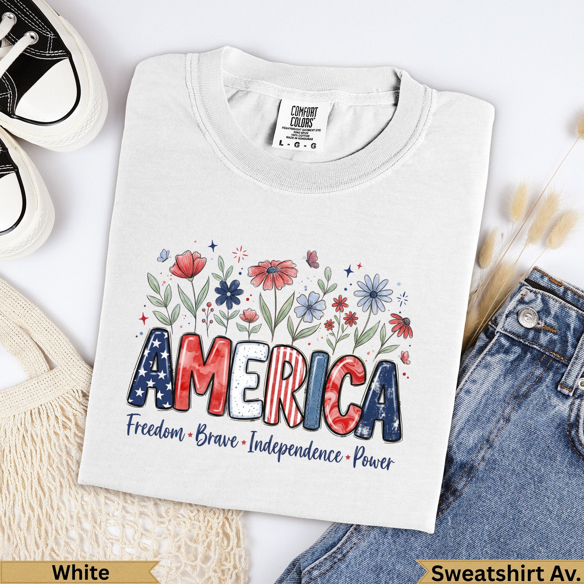 White Comfort Colors t-shirt with "AMERICA" in bold letters, surrounded by flowers and text.