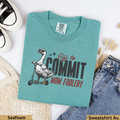 Teal Comfort Colors sweatshirt with a goose on a scooter saying "Off to Commit Mom Foolery."