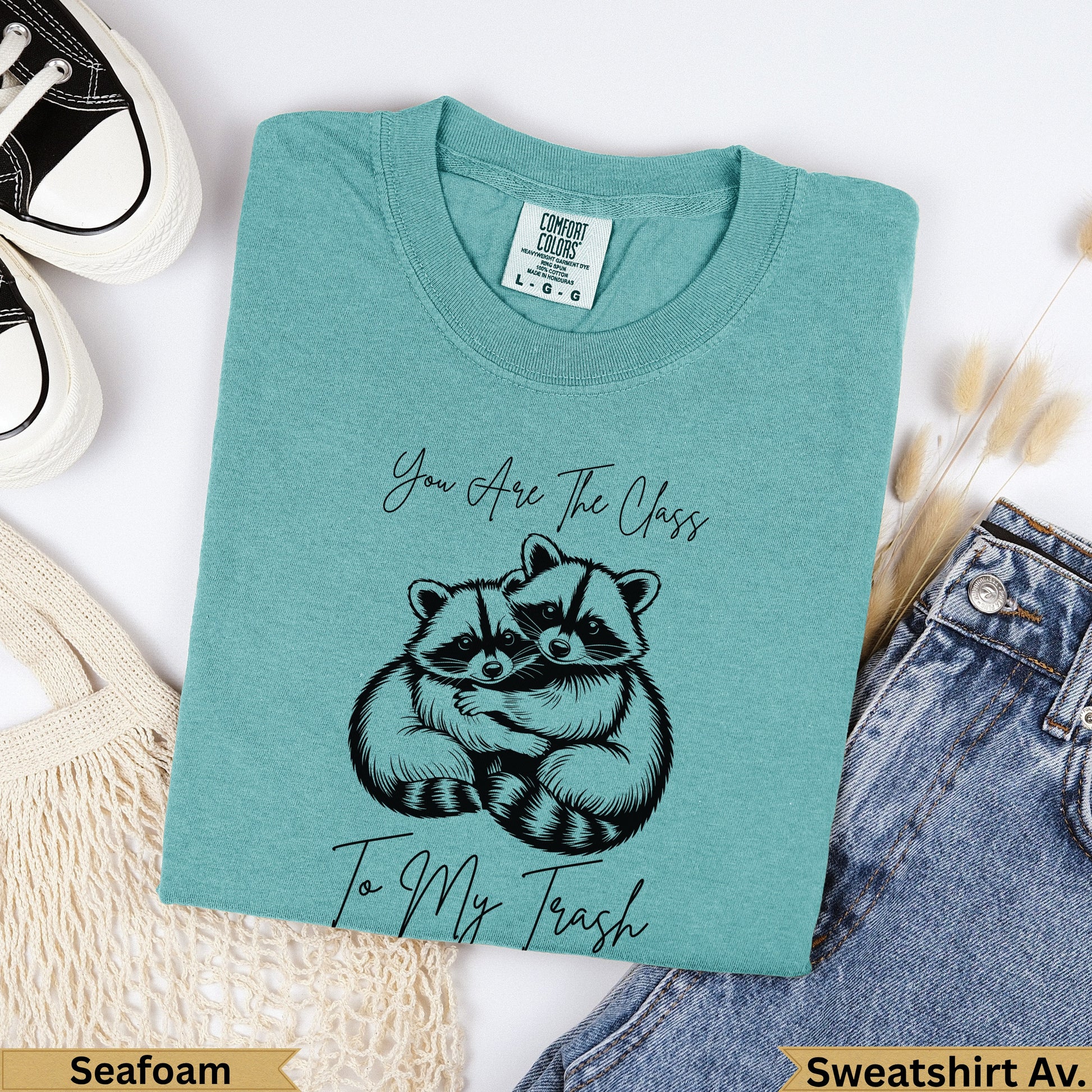 Teal sweatshirt with two raccoons hugging and text "You Are The Class To My Trash".