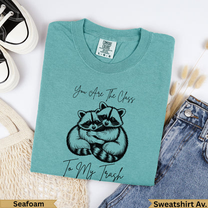 Teal sweatshirt with two raccoons hugging and text "You Are The Class To My Trash".
