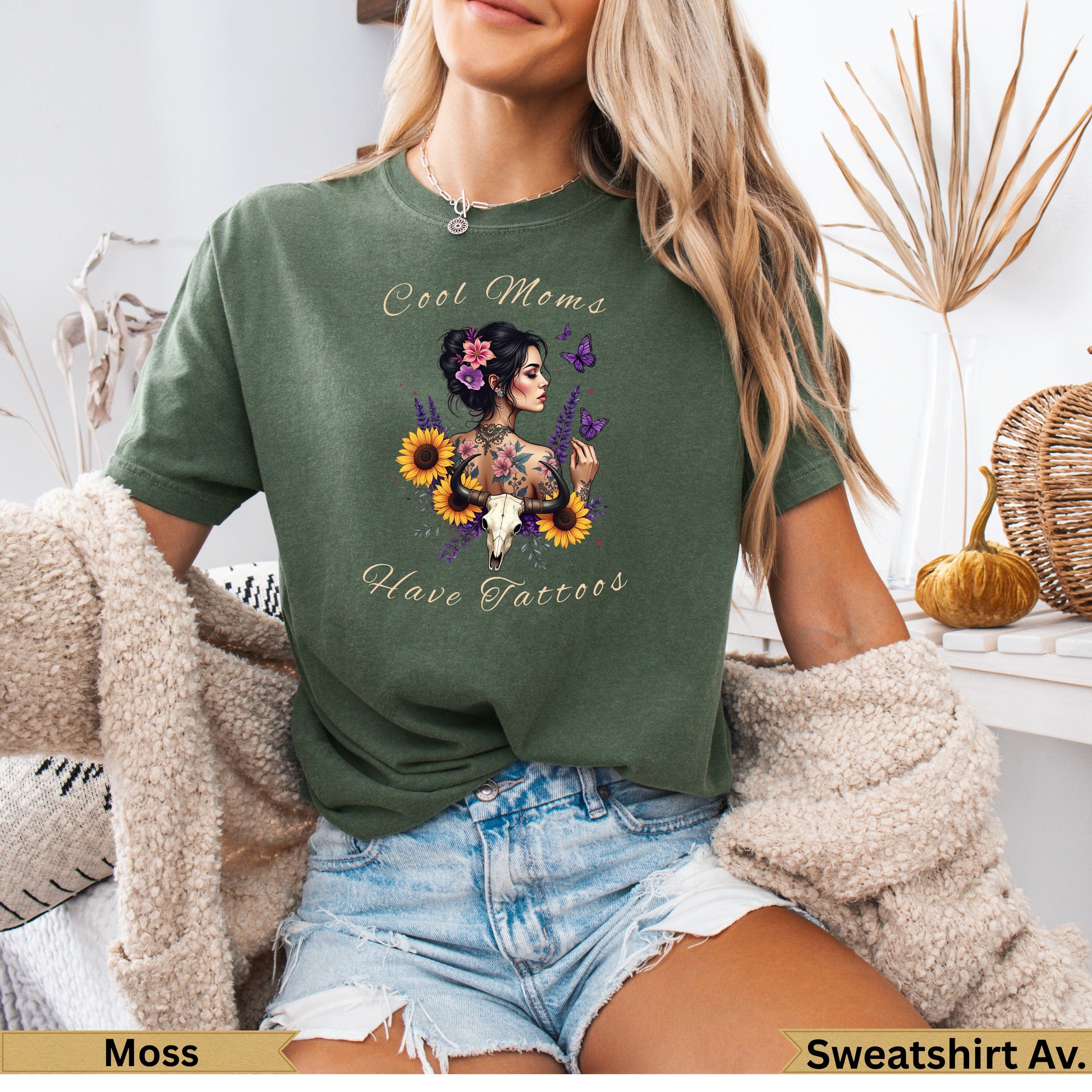 Green t-shirt with "Cool Moms Have Tattoos" and floral skull design.