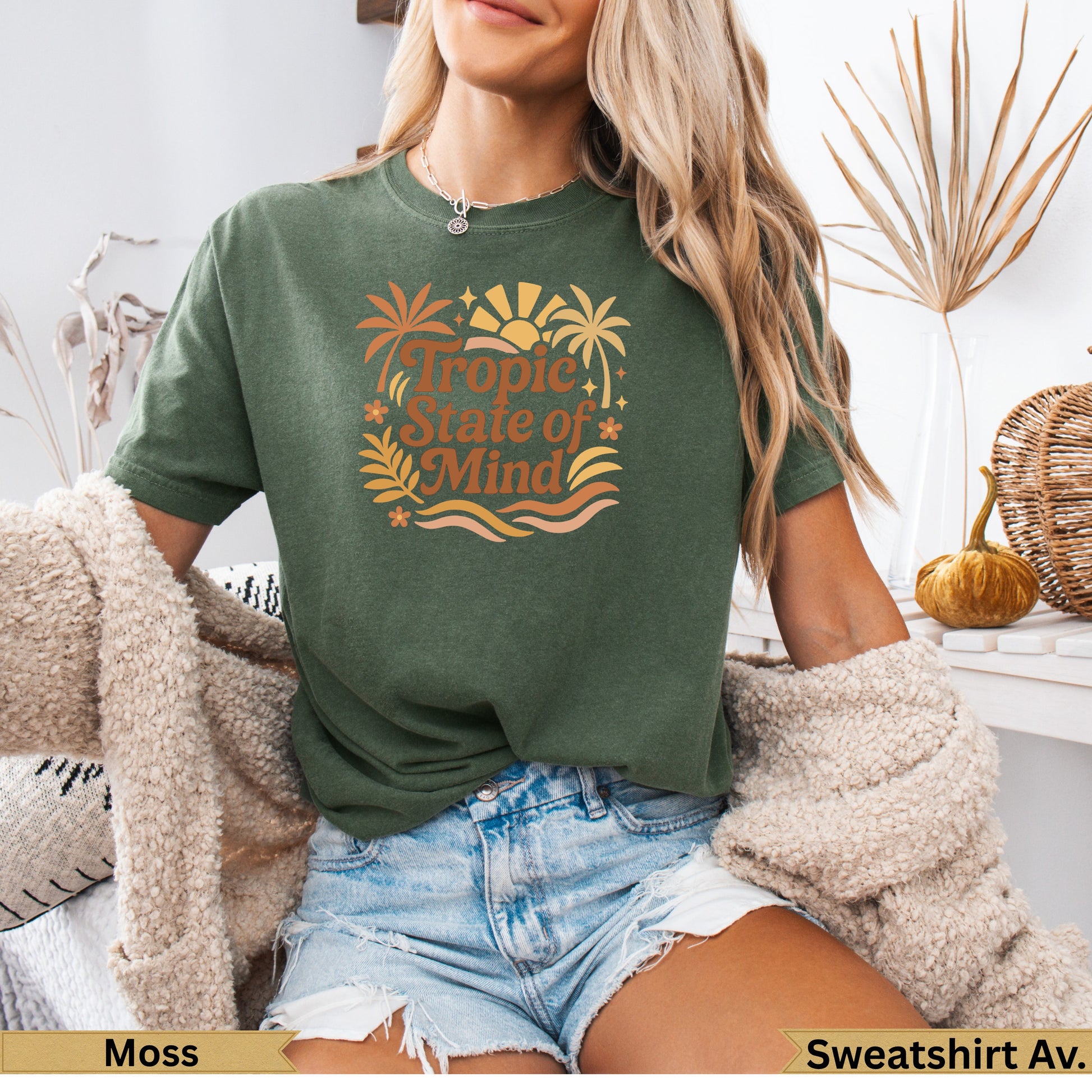 Green t-shirt with "Tropic State of Mind" graphic featuring palm trees and sun.