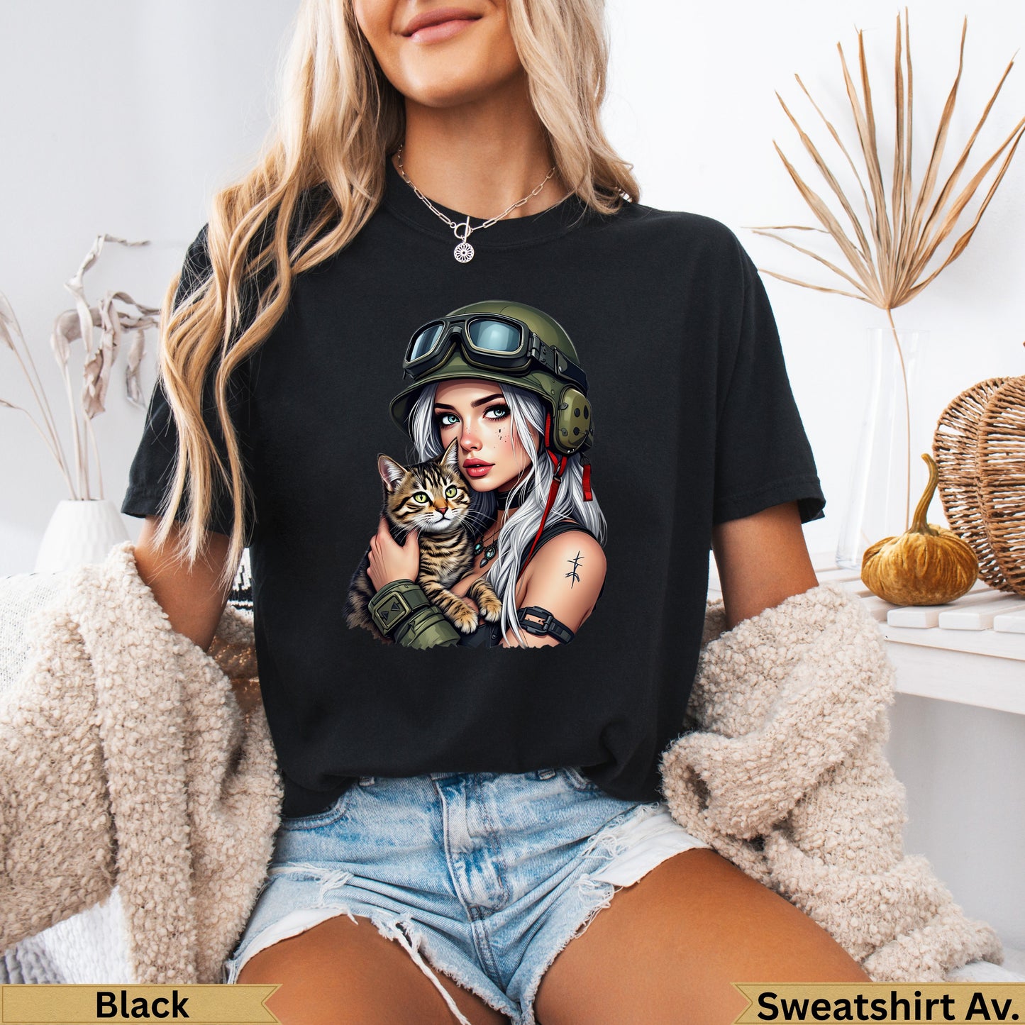Woman in black t-shirt holding a cat, wearing military-style helmet and goggles.