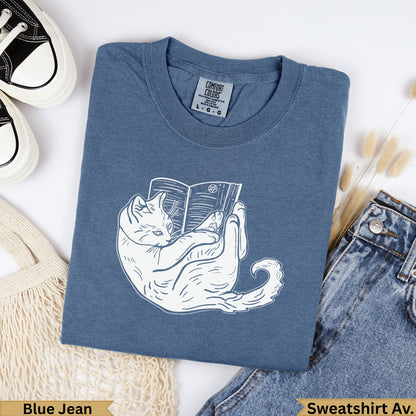 Blue Jean Comfort Colors sweatshirt with white cat reading a book graphic.