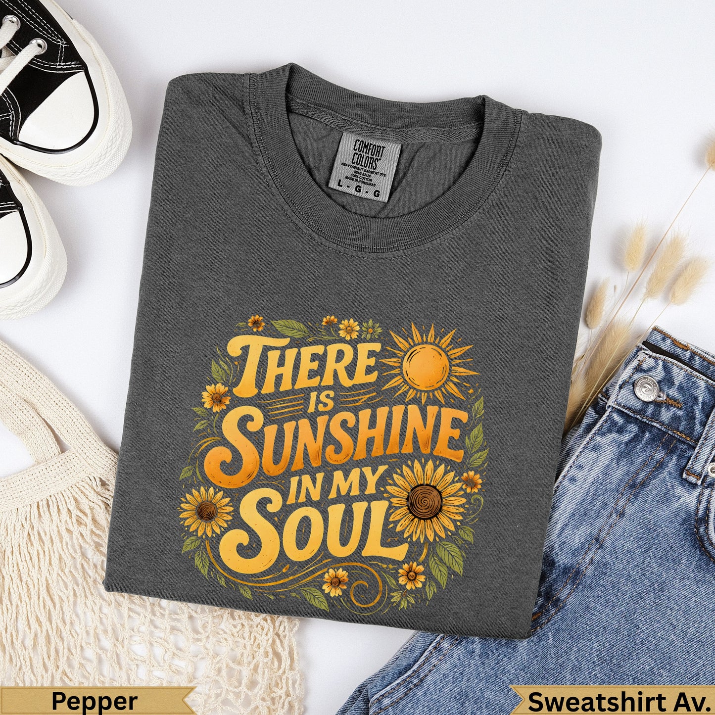 Dark grey sweatshirt with "There is sunshine in my soul" graphic.