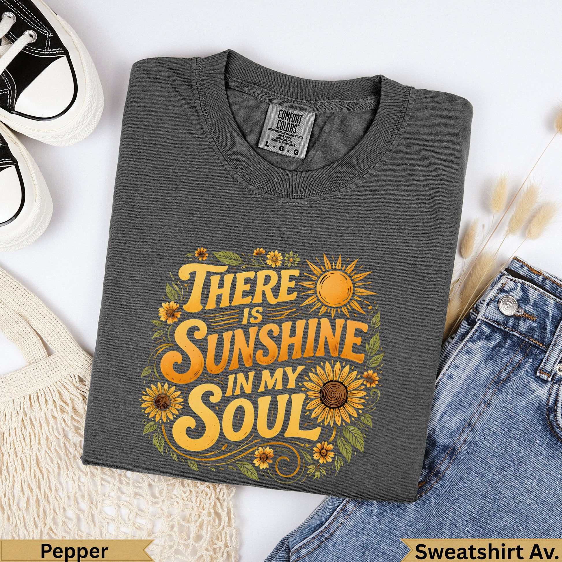 Dark grey sweatshirt with "There is sunshine in my soul" graphic.