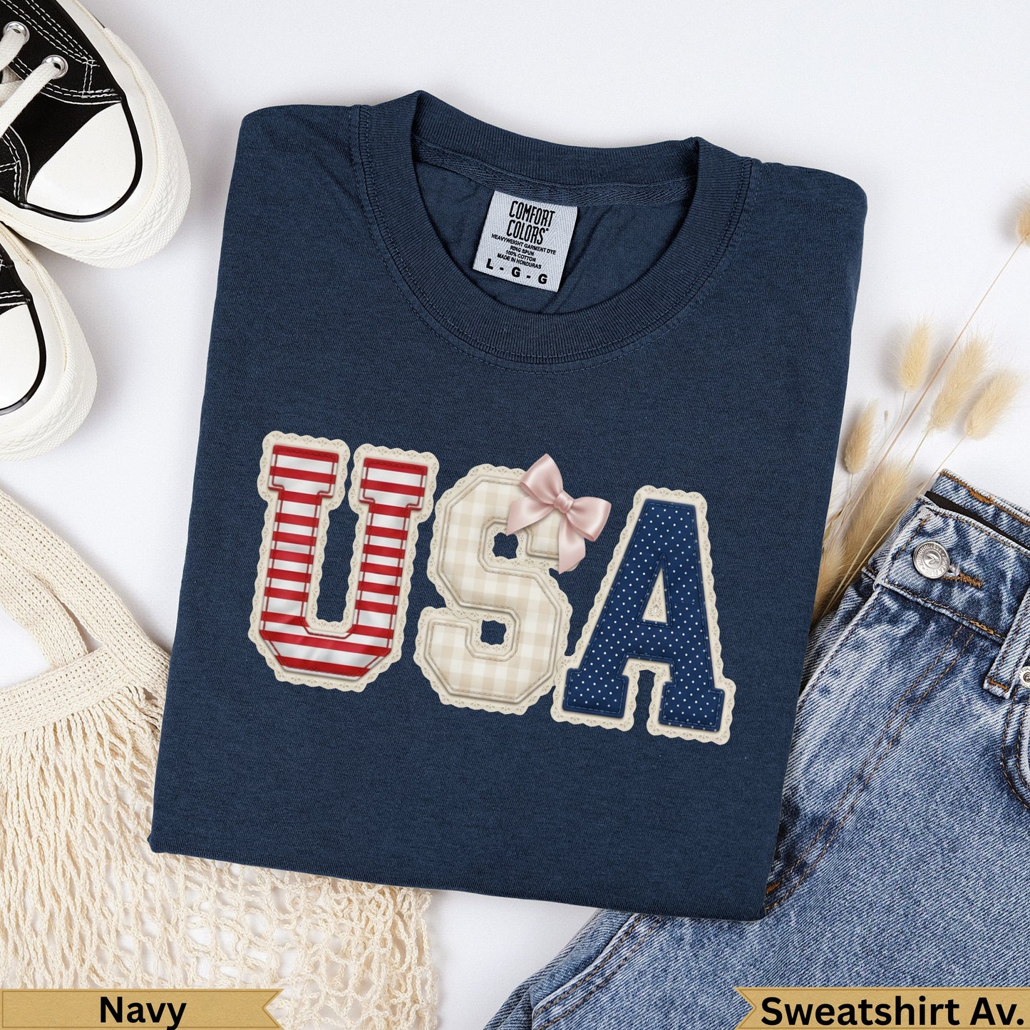 Navy Comfort Colors USA sweatshirt with checkered and striped letters and pink bow.