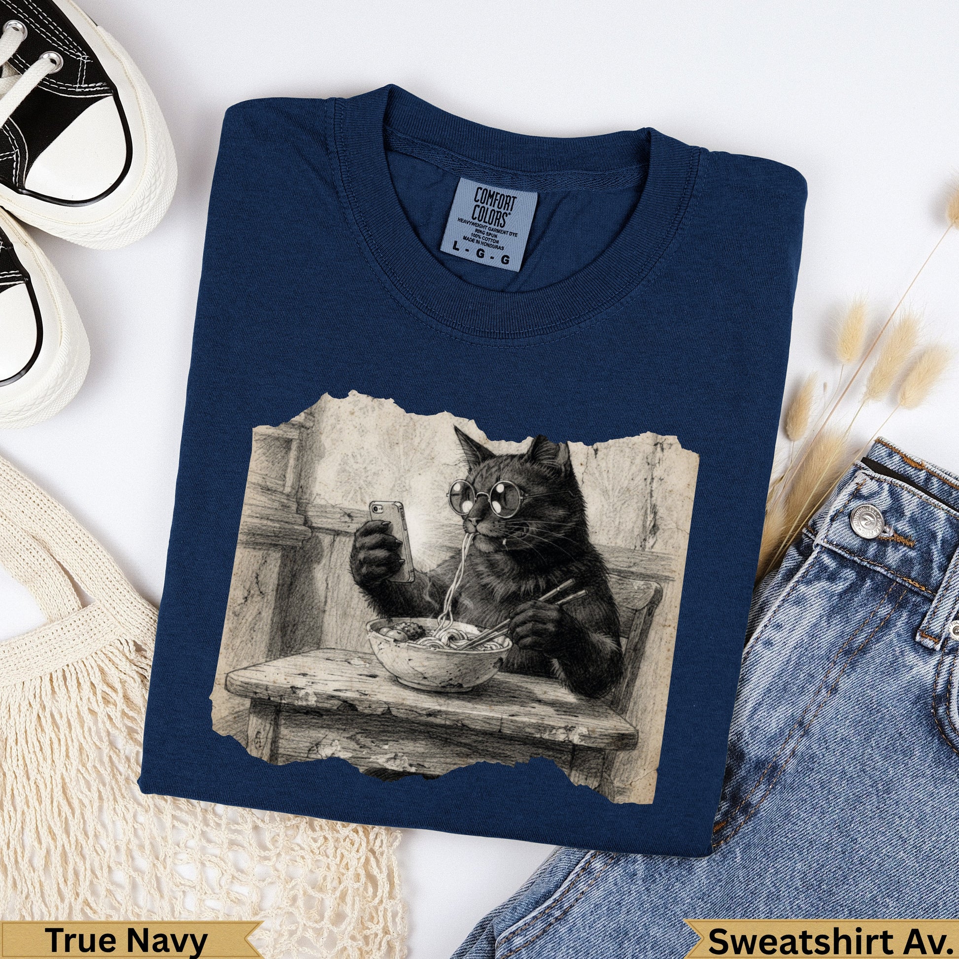 Navy crewneck sweatshirt with graphic of a cat wearing glasses eating noodles.