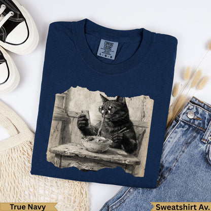 Navy crewneck sweatshirt with graphic of a cat wearing glasses eating noodles.