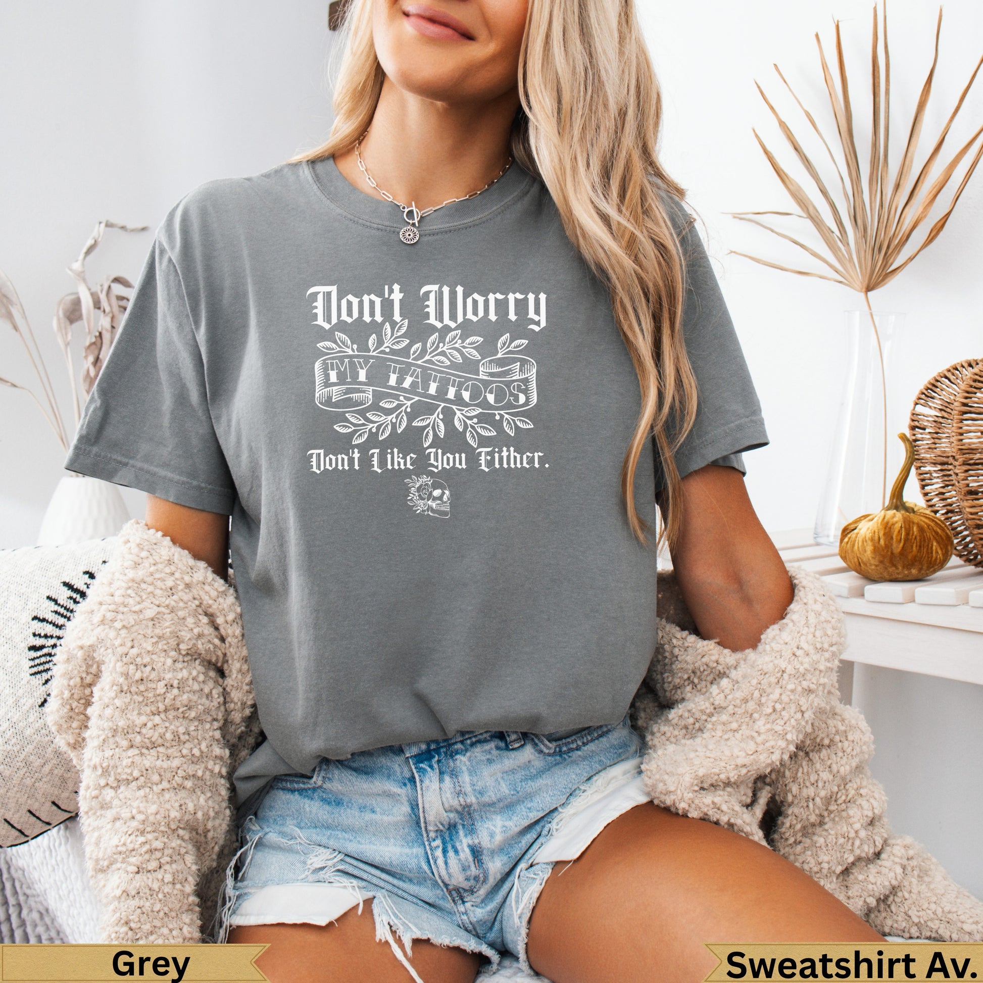 Grey t-shirt with "Don't Worry, My Tattoos Won't Bite" text and skull graphic.