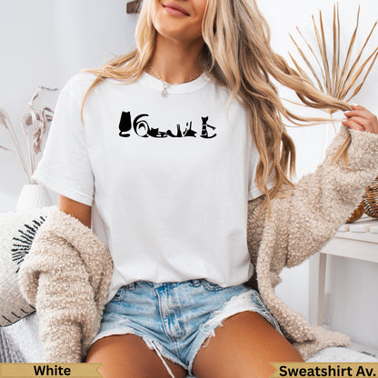 White t-shirt with silhouette of cats in various poses and "Sweatshirt Av." text.