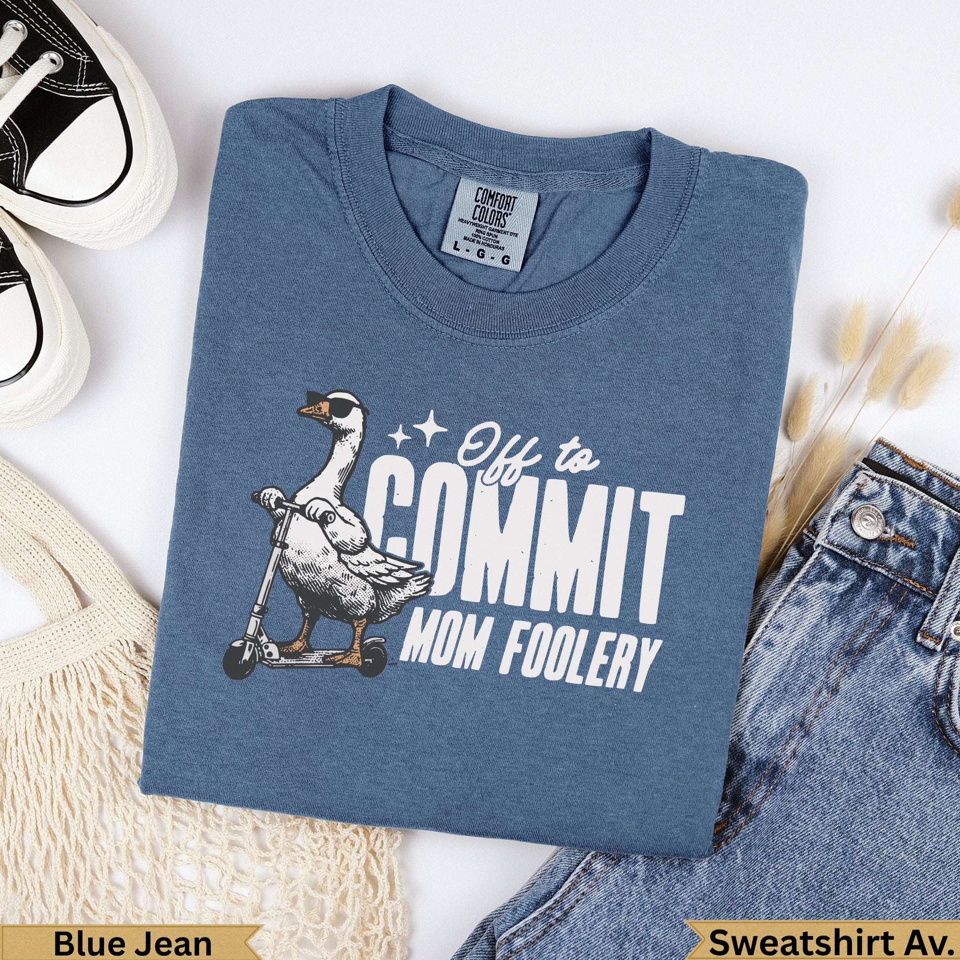 Blue Jean Comfort Colors sweatshirt with a goose on a scooter saying "Off to commit mom foolery".