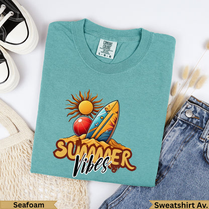 Teal crewneck sweatshirt with "Summer Vibes" graphic of sun, beach ball, and surfboard.