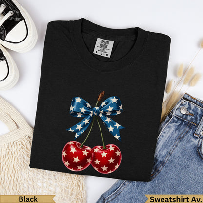 Black t-shirt with red cherries and a blue bow with white stars.