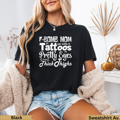 Black t-shirt with white text "F-BOMB MOM with Pretty Eyes and Thick Thighs".