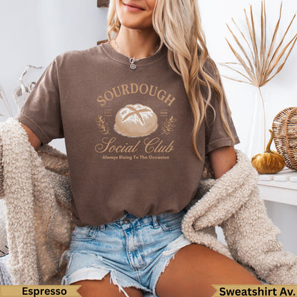 Brown sweatshirt with "Sourdough Social Club" text and a loaf of bread graphic.