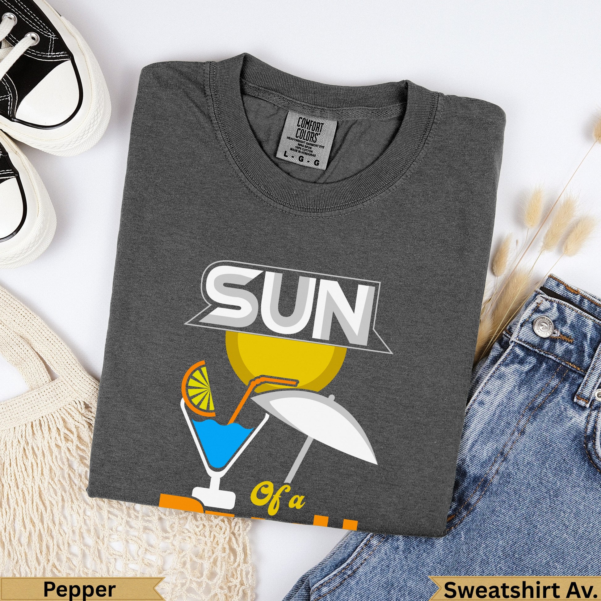 Dark gray Comfort Colors sweatshirt with "SUN" graphic and beach scene.