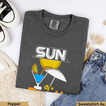 Dark gray Comfort Colors sweatshirt with "SUN" graphic and beach scene.