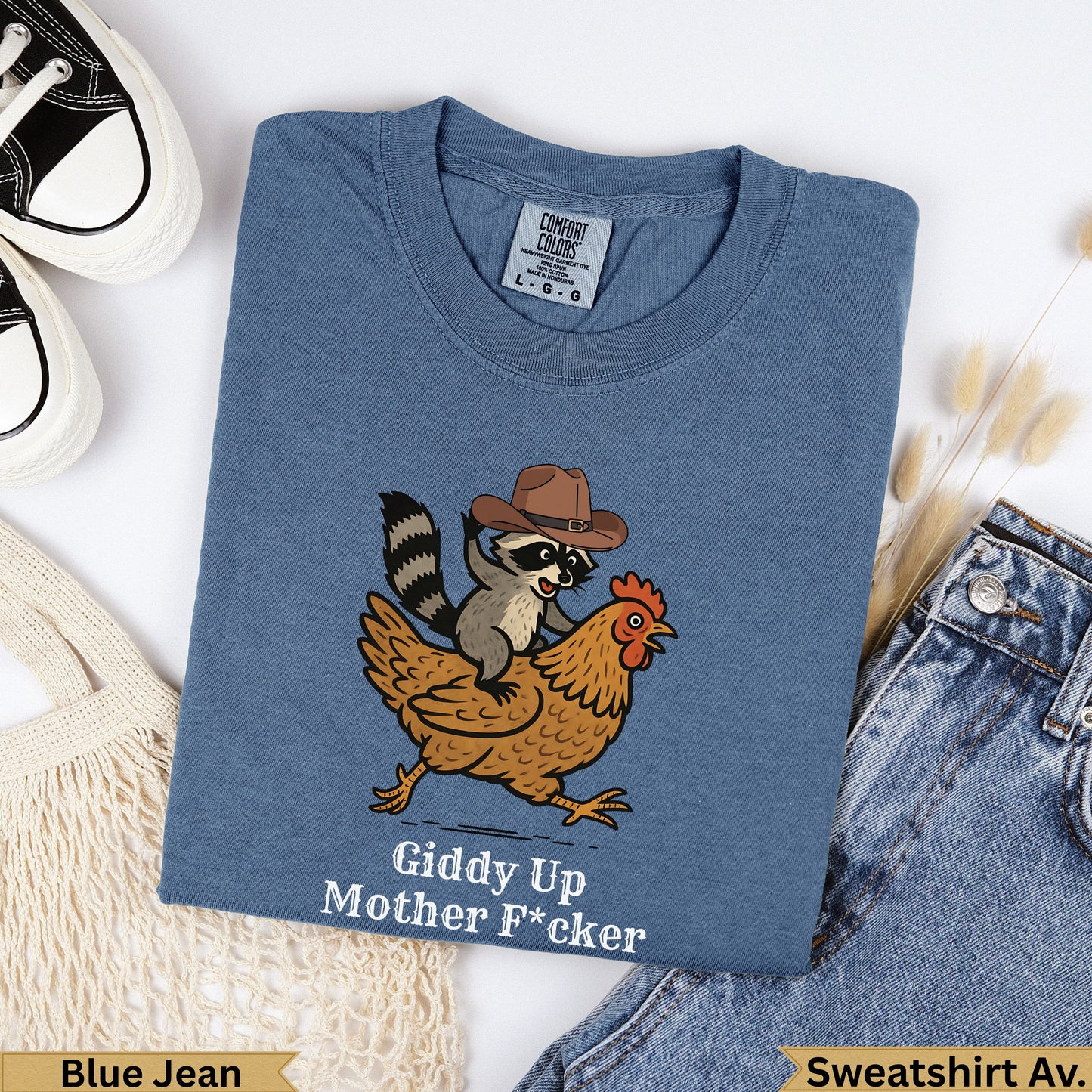 T-shirt with raccoon in cowboy hat riding chicken, text "Giddy Up Mother F*cker".