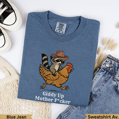 T-shirt with raccoon in cowboy hat riding chicken, text "Giddy Up Mother F*cker".