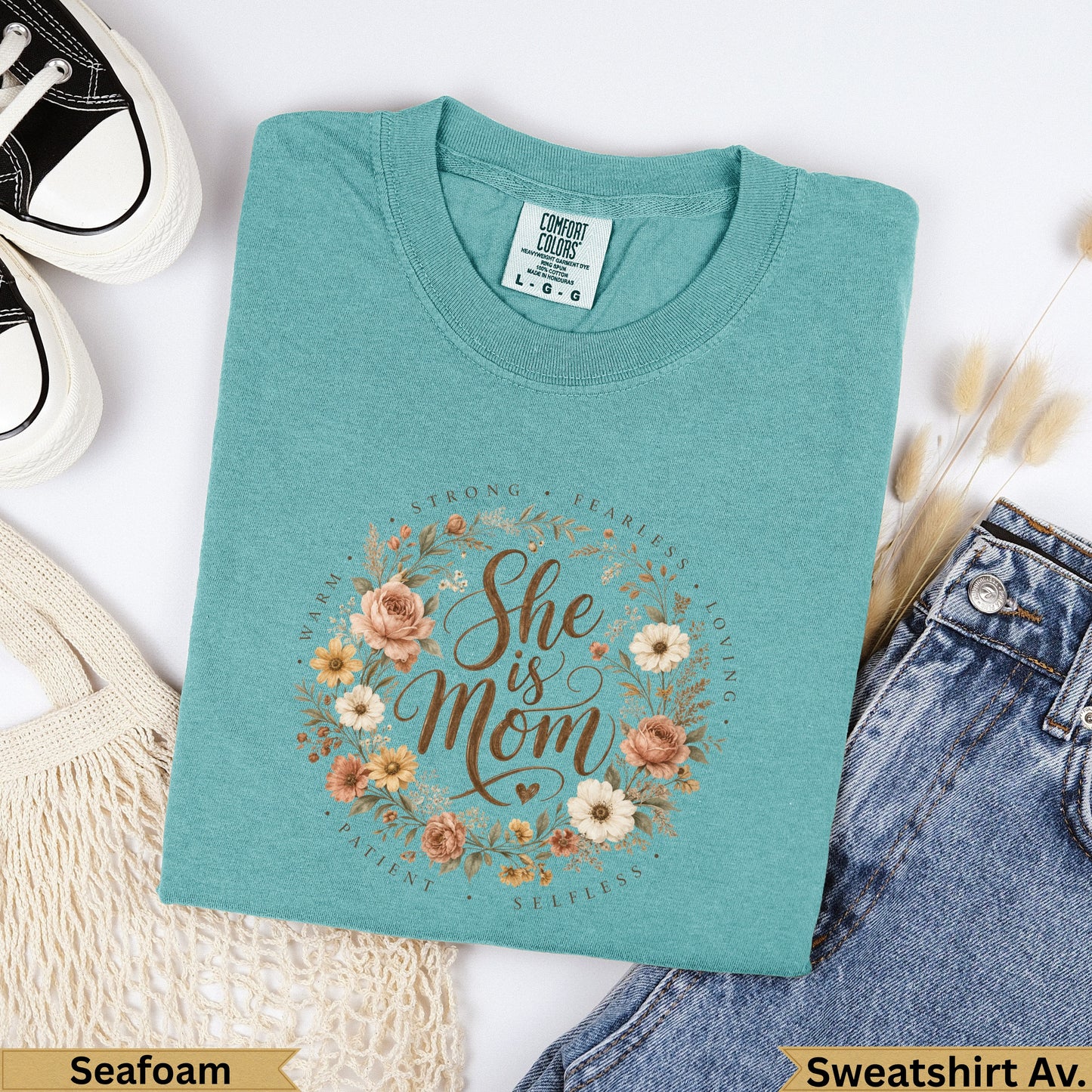 Teal Comfort Colors sweatshirt with "She is Mom" floral wreath design.