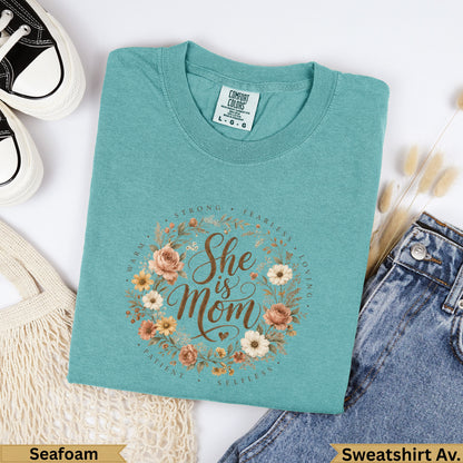 Teal Comfort Colors sweatshirt with "She is Mom" floral wreath design.