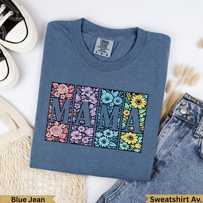Blue t-shirt with "MAMA" in floral-filled squares, with jeans and a bag.