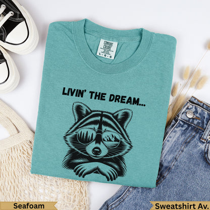 Teal Comfort Colors sweatshirt with raccoon graphic and text "LIVIN' THE DREAM...".